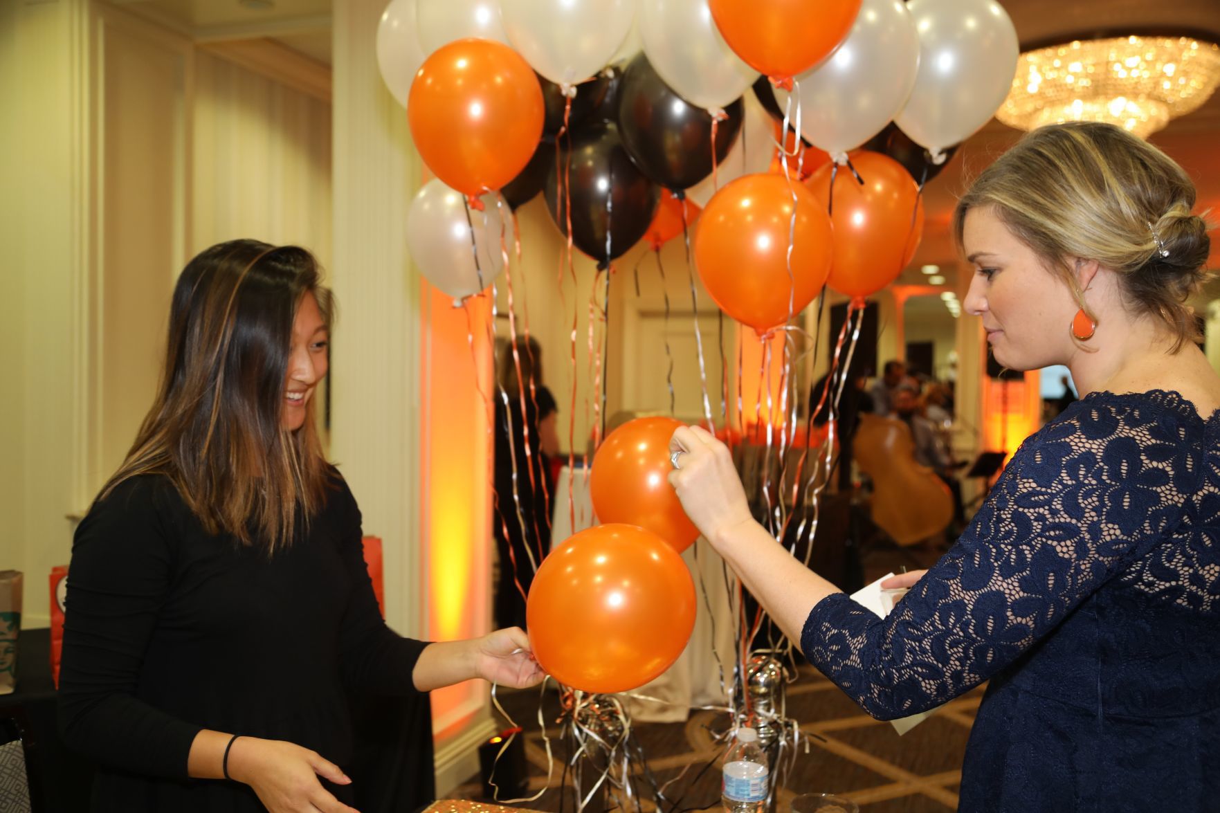 Annette Hall pops balloon